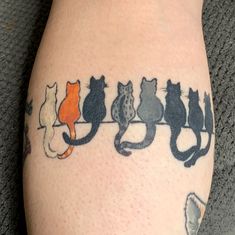 there are many cats sitting on a wire tattoo design that looks like they're all lined up