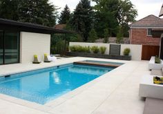 an empty swimming pool in the middle of a backyard