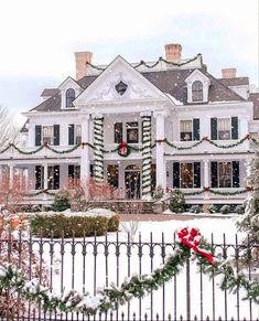 a large white house covered in christmas decorations