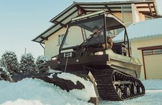 a snow plow is parked in front of a house