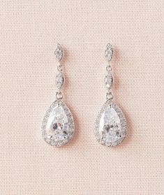 "I've personally designed and created the Leigh jewelry. Classic styling perfectly defines these gorgeous and elegant earrings and necklace. I've created these with a beautiful halo pear shape drops. I use only high quality chains/materials. All my jewelry is nickel free. Total length of earrings 1.5\" Length of Pendant drop - 1.5\" Matching Bracelet: https://www.etsy.com/listing/162583809/crystal-wedding-bracelet-bridal-bracelet Please message me with any questions! Thank you for looking Sue x" Hand-set Silver Bridal Earrings For Marriage, Silver Hand-set Bridal Earrings For Marriage, Diamond Crystal Earrings For Wedding, Silver Bridal Earrings For Marriage, Hand Set Silver Bridal Earrings, Silver Hand Set Bridal Earrings For Marriage, Hand Set Crystal Bridal Earrings For Wedding, Diamond Drop Crystal Earrings For Wedding, Diamond White Crystal Bridal Earrings For Wedding