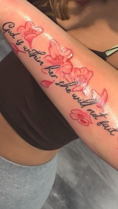 a woman's arm with flowers and words on it