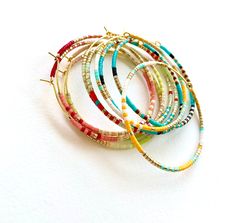 Large, hand-beaded boho-style hoop earrings. Very light weight.  4 beautiful color combinations to choose from. Made with very high quality Japanese beads. Gold plated, 45 mm (1.75 inches) hoops.  🌎 Packaging 🌎 To be environmentally responsible about packaging we will package orders together in the same box. If certain items in your order are intended as gifts and you'd like individual boxes, please leave a note during checkout. To view more items from this shop, click the link below:  https:/ Seed Bead Hoop Earrings, Hoop Earrings Large, Bead Hoop Earrings, Boho Hoop Earrings, Minimalist Necklace Gold, Japanese Beads, Gold Bead Necklace, Beading Ideas, Minimalist Bracelet