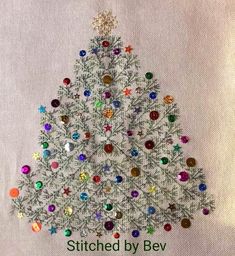 a christmas tree made out of buttons on a white background with the words stitched by bev