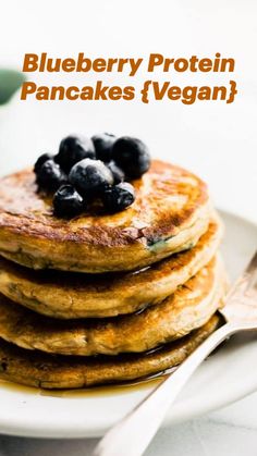 stack of pancakes with blueberries on top and text overlay reading blueberry protein pancakes vegan