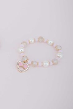 "Our NEW Boutique collection boasts a meticulously curated selection of necklaces, bracelets, headbands and hair accessories. The Boutique Love bracelet is one of our most elegant bracelets yet! Strung with pink, white, and gold beads and finalized with a rhinestone incrested heart & bow charm. This bracelet is so sweet, it even has a matching necklace! I design all costumes and accessories & have developed a patterning process for ultimate sizing flexibility. Due to our lucky growth over the pa Bracelet For Kids, Bracelets Pink, Packaging Jewelry, Necklace Product, Jewelry Heart, Kids Bracelets, Boutique Collection, Love Bracelet, The Boutique