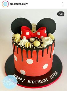 a mickey mouse cake is decorated with white and red icing