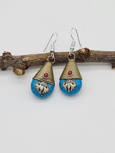 These are elegant Tibetan blue teardrop earrings from Nepal.  Each pair has been handcrafted with Tibetan beads made from resin. Earrings are very lightweight ( 3.7 g each) Earrings come with a pretty pouch.  *We have various colours and styles - Please check our listings *All our jewellery are handmade, hence imperfections might be present, however it makes each item truly unique. *Delivery: parcel is sent with a standard delivery. No tracking number is provided. Bohemian Blue Teardrop Earrings For Gifts, Blue Bohemian Teardrop Earrings For Gift, Blue Bohemian Teardrop Earrings Gift, Bohemian Teardrop Blue Earrings, Bohemian Beaded Blue Teardrop Earrings, Adjustable Blue Bohemian Teardrop Earrings, Bohemian Blue Beaded Teardrop Earrings, Bohemian Teardrop Earrings With Matching Pair, Bohemian Blue Teardrop Earrings