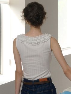 This product, the Lace Neck Sleeveless Top, combines classic and contemporary elements beautifully. It features a sophisticated lace-trimmed neckline, adding a delicate and feminine touch to the design. The fitted silhouette complements the wearer's figure, making it an excellent choice for both casual and more formal settings. - This Lace Neck Sleeveless Top is highlighted by an ornate lace collar that frames the face elegantly.- It is constructed from a soft, ribbed fabric that ensures a comfortable fit while providing a subtle texture.- The sleeveless design makes this top a perfect choice for warm weather, allowing for ease of movement and layering.- A slight stretch in the fabric allows it to conform gracefully to different body types, enhancing comfort and wearability. Elegant Sleeveless Lace Top With Collar, Feminine Sleeveless Lace Blouse, Feminine Sleeveless Stretch Lace Top, Feminine Stretch Sleeveless Lace Top, Elegant White Tank Top With Lace Trim, Elegant White Lace Trim Tank Top, Fitted Lace Trim Tank Top, Chic Sleeveless Top With Lace Collar, Feminine Lace Trim Sleeveless Blouse Tank Top