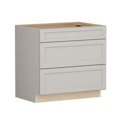 a white cabinet with two drawers on the bottom and one drawer in the middle, against a