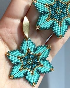 the beaded earrings have been made to look like snowflakes, and are blue with gold accents