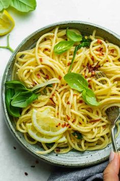 a bowl filled with pasta and garnished with herbs