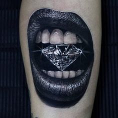 a woman's mouth with a diamond on it and her teeth are painted black