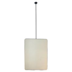 a white square light hanging from a ceiling