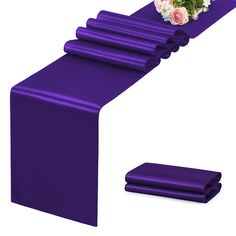 a purple table runner with flowers on it