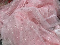 pink tulle with silver stars and sequins on the bottom is laying down