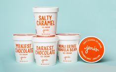 three cups of ice cream next to an orange label