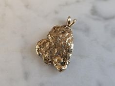 A VINTAGE ESTATE 14K YELLOW GOLD NUGGET PENDANT. THE TOTAL WEIGHT IS 4.9g, AND MEASURES 1" LONG BY 5/8" WIDE.  PIECE IS NOT MARKED BUT IT HAS BEEN TESTED.   MAKES A GREAT GIFT FOR THAT SOMEONE SPECIAL.   ANY QUESTIONS, PLEASE ASK.  BE SURE TO CHECK OUT SOME OF MY OTHER GREAT ITEMS FOR SALE. 14k Stamped Yellow Gold Nugget Jewelry, Classic Hallmarked Nugget Jewelry, Fine Jewelry Yellow Gold Nugget, Fine Jewelry In Yellow Gold Nugget Shape, 14k Yellow Gold Nugget Jewelry, Yellow Gold Nugget Fine Jewelry, Polished Yellow Gold Nugget Jewelry, Antique Yellow Gold Jewelry With Hammered Details, Antique Hammered Yellow Gold Jewelry