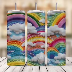 three colorful tumbles with clouds and rainbows on them