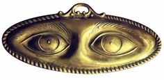 a brass plate with an eye in the center and two smaller eyes on each side