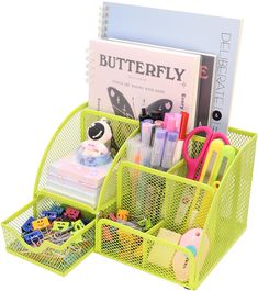 a green desk organizer with pens, scissors and other office supplies in the bins