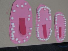 two pink and white plastic plates with marshmallows on them, sitting on a table