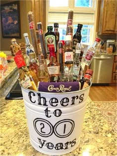 a bucket filled with liquor bottles sitting on top of a counter