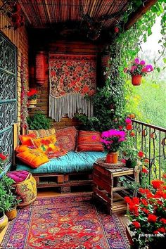 a porch with lots of flowers and plants on it