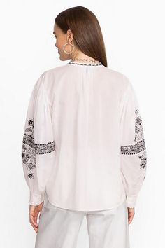 The Irenie Kivi Blouse is crafted from breathable, 100% cotton fabric. Featuring a split V-neckline with gathers at the neck and sleeves, this lightweight blouse is finished with intricate placement embroidery and ruffling at the cuffs. Pair with classic denim and fashion sneakers for a weekend look with impeccable style. Johnny Was Women's Kivi Blouse in White, Size XS, Cotton/Denim Peasant Cotton Blouse With Bishop Sleeves, Cotton Tops With Gathered Sleeves For Daywear, Peasant Style Cotton V-neck Blouse, Cotton Peasant Top V-neck, Cotton Peasant Top With Bishop Sleeves, Peasant Style Cotton V-neck Top, Cotton Peasant Top With V-neck, Bohemian Cotton Blouse With Bishop Sleeves, Cotton Peasant Blouse For Daywear