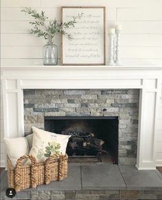 a living room with a fire place and some pillows on the fireplace mantels