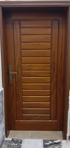 a wooden door with a metal handle on it