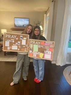 two girls holding up signs that say pray