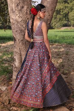 Red and blue handwoven patola motifs on pure silk lehenga. Comes with hand embroidered blouse with mirror embellished hem. Paired with crushed dupatta with gota patti work  and Meenakari kamarbandh. 
Components:4
Pattern:Embroidered
Type of Work:Resham, Zardozi, Gota, Mirror
Neckline:Plunge V-neck
Sleeve Length:Sleeveless
Fabric:Lehenga: Banarasi Silk; Blouse: Pure Silk; Dupatta: Crush Silk
Color:Blue
Other Details:
Tassel hem kamarbandh and blouse
Draped layered lehenga
Occasion:Wedding - Aza F Patola Motifs, Patola Lehenga, Aditi Gupta, Lehenga Banarasi, Layered Lehenga, Hand Embroidered Blouse, Gota Patti Work, Blue Lehenga, Silk Lehenga