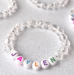 Crystal - Rainbow Kids Personalized Name Bracelet. You will receive (1) one bracelet  Made using; 8mm Faceted Clear Acrylic Beads, Color Letter Beads & durable 1mm elastic cord Personalized name bracelets make the perfect gift for your little one. Custom jewelry makes the perfect birthday gift! Make it extra special order a matching set.  Looking for a personalized cute gift for your students, or your child's Classmates? look no further. This is the perfect gift for your classmates! Show off tha White Letter Beads Charm Bracelet, White Round Charm Bracelet With Letter Beads, Adjustable Beaded Bracelets For Birthday, Custom Name Beaded Bracelet For Birthday, Birthday Charm Bracelet With Round Beads And Adjustable Fit, Personalized Beaded Bracelets For Birthday, White Letter Beads Bracelet For Birthday, Adjustable Charm Bracelet With Round Beads For Birthday, Colorful Beads Stretch Bracelet For Birthday