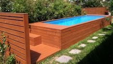 an above ground pool surrounded by grass and trees