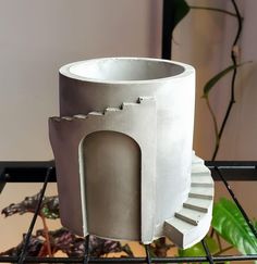 a white cup sitting on top of a metal rack