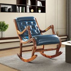 a wooden rocking chair with blue leather upholstered on the seat and back, in a living room