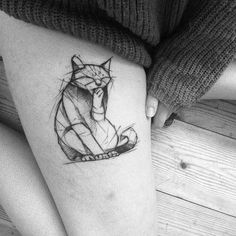 a woman's thigh with a tattoo of a cat sitting on top of it