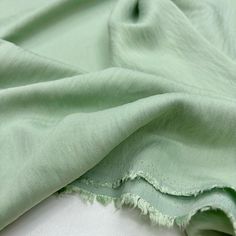 the fabric is very soft and green with some fraying on it's edges