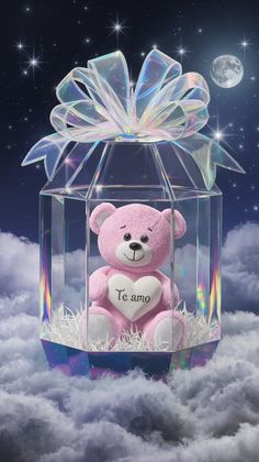 a pink teddy bear sitting in a clear box