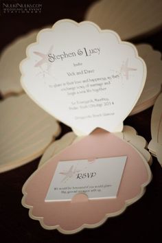 the wedding stationery is displayed in pink and white