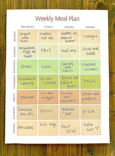 a printable meal plan on top of a wooden table