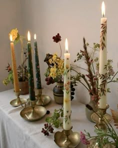 a table topped with lots of different types of candles