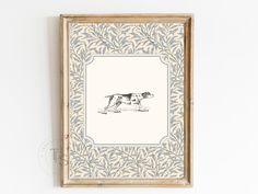 a framed drawing of a dog on a white wall next to a brown and blue frame