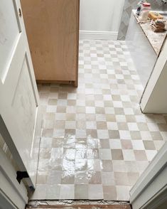 a kitchen floor that is being remodeled with tile on the floor and in between cabinets