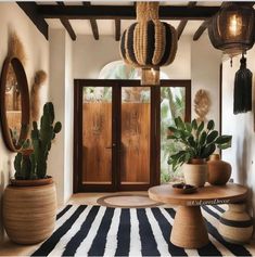 a living room filled with lots of plants and potted plants in front of a wooden door