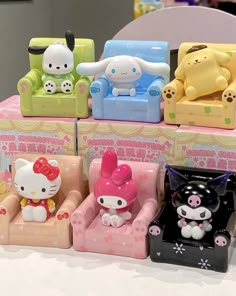 hello kitty toys are sitting on top of each other in the shape of couches