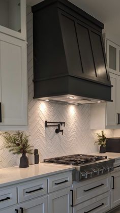 a stove top oven sitting inside of a kitchen next to white cabinets and counter tops