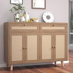 a wooden cabinet with two doors and some pictures on the wall next to it in a room