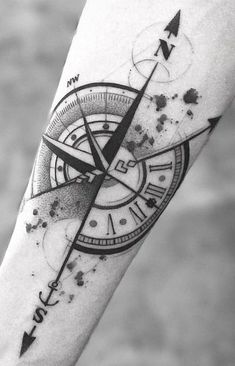 a black and white photo of a compass tattoo